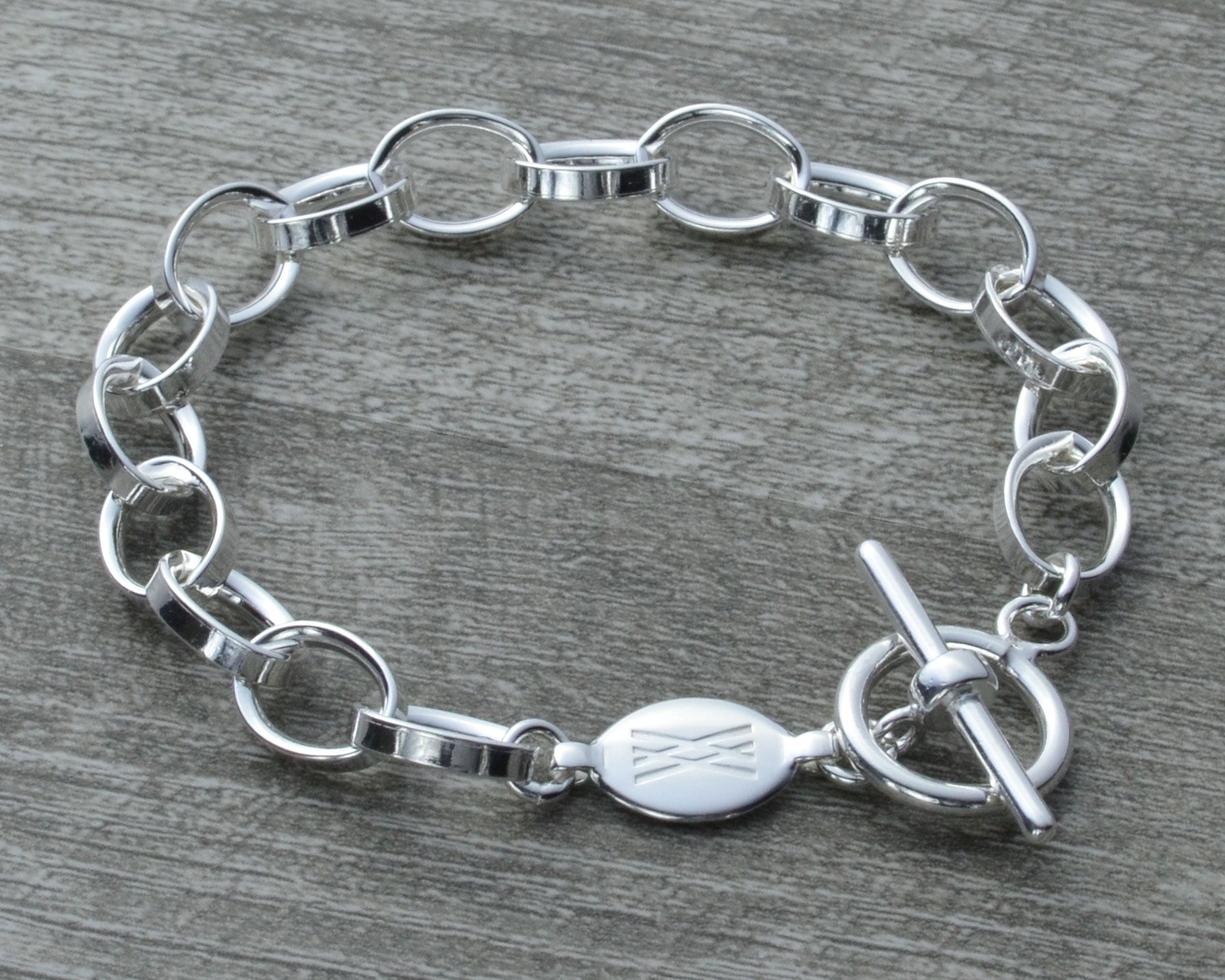 Lovely Sterling Silver Charm Bracelet with Toggle Lock. Available in 2 Sizes.