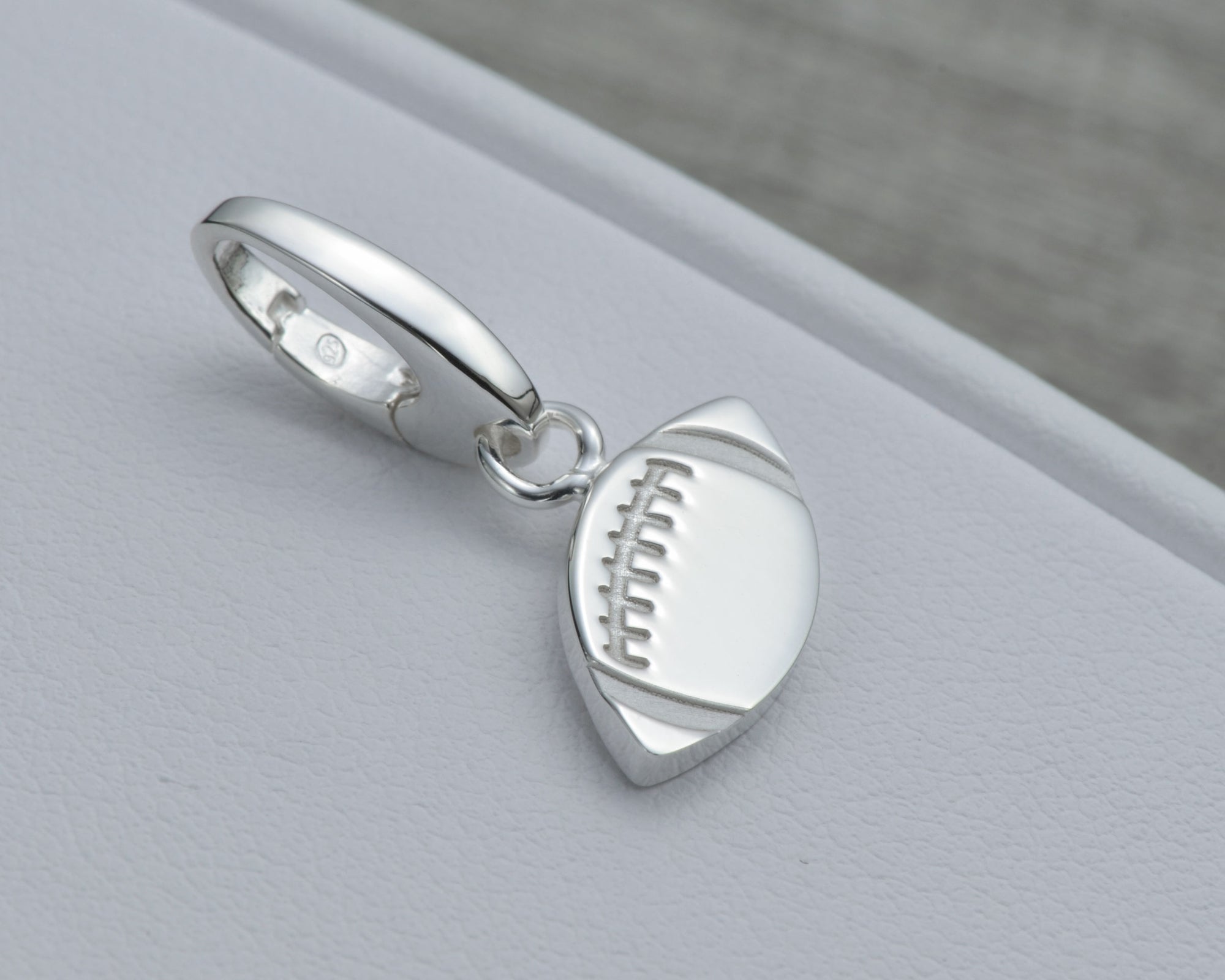 FOOTBALL CHARM IN STERLING SILVER